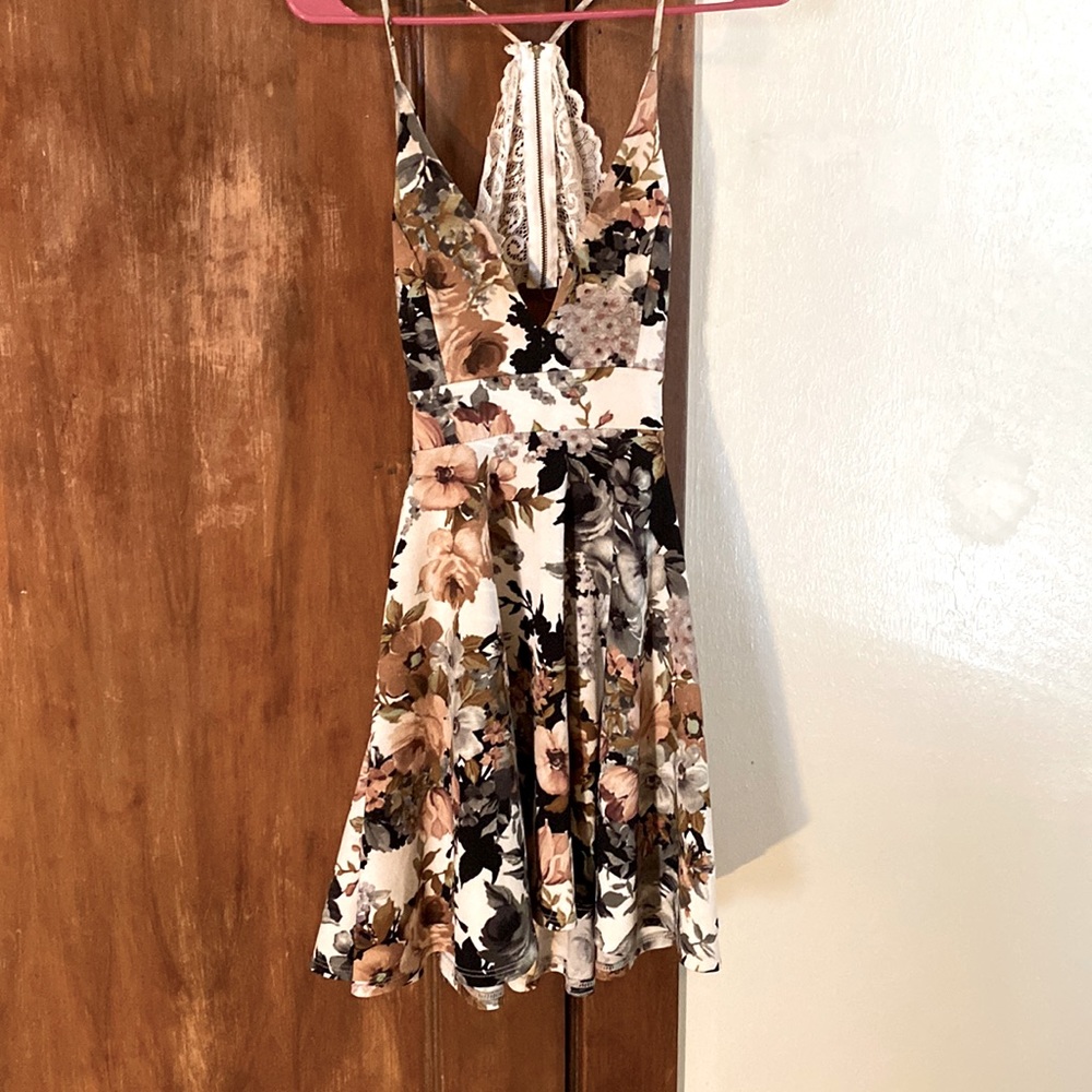 Floral mini dress. Lace zip up with a cut out on lower back.